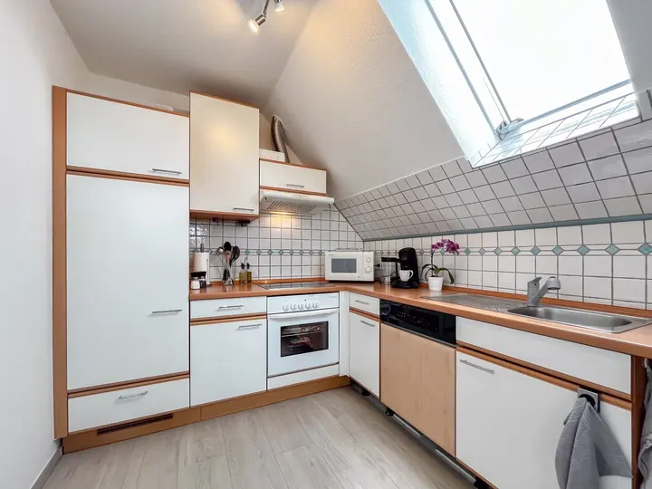 Fully equipped kitchen beneath a skylight